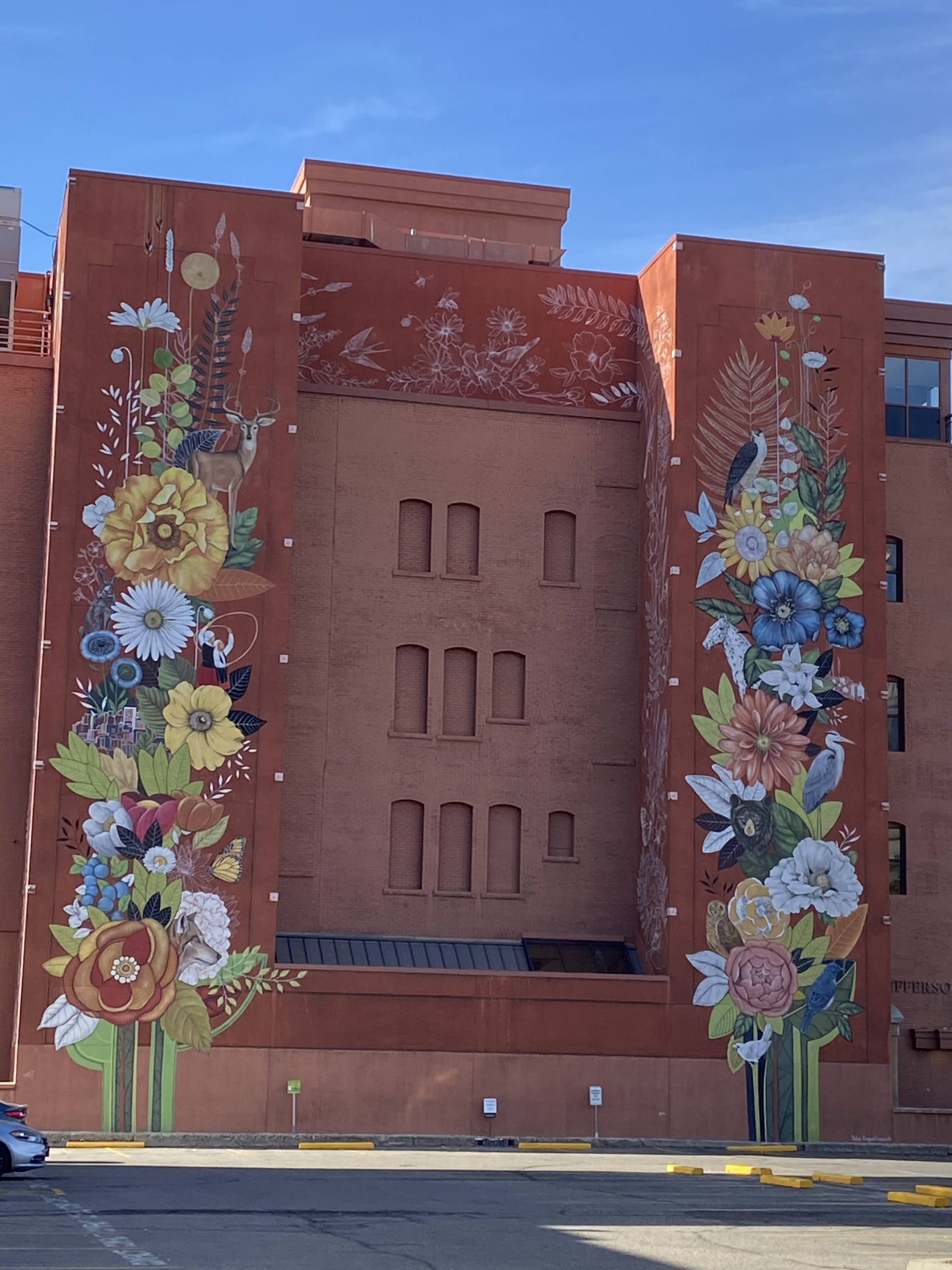 A mural of flowers and birds painted n the outside of a building in Boise, Idaho