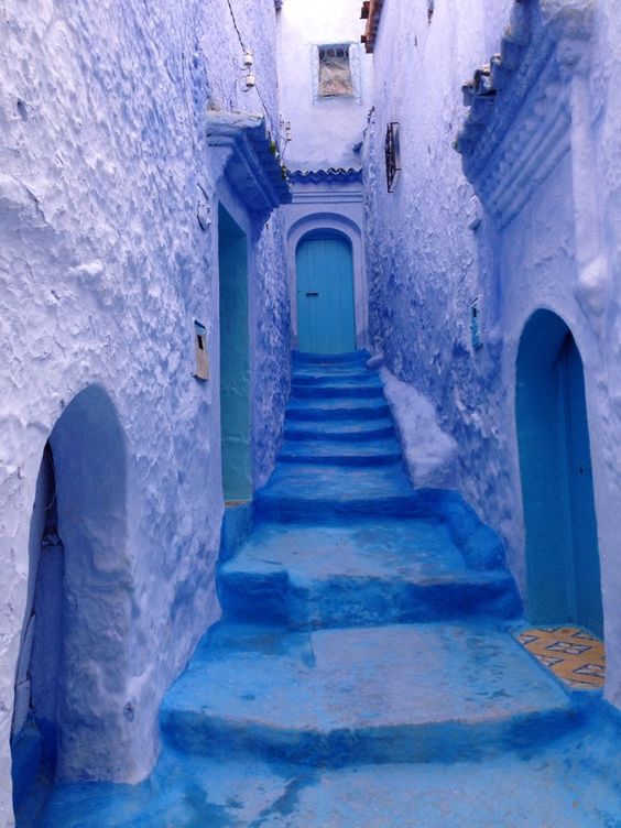 Photo of a staircase leading to a door alll in various colors of blue