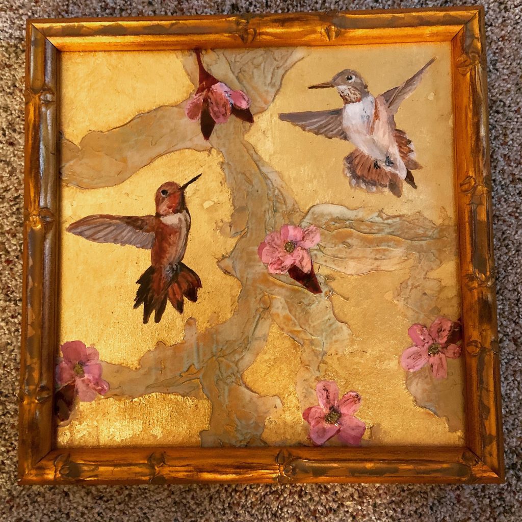 Painting of a male and female hummingbird painted on gold leaf. 