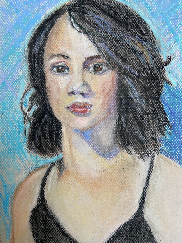 Pastel Portrait of a young woman painted with pastel paints. 
